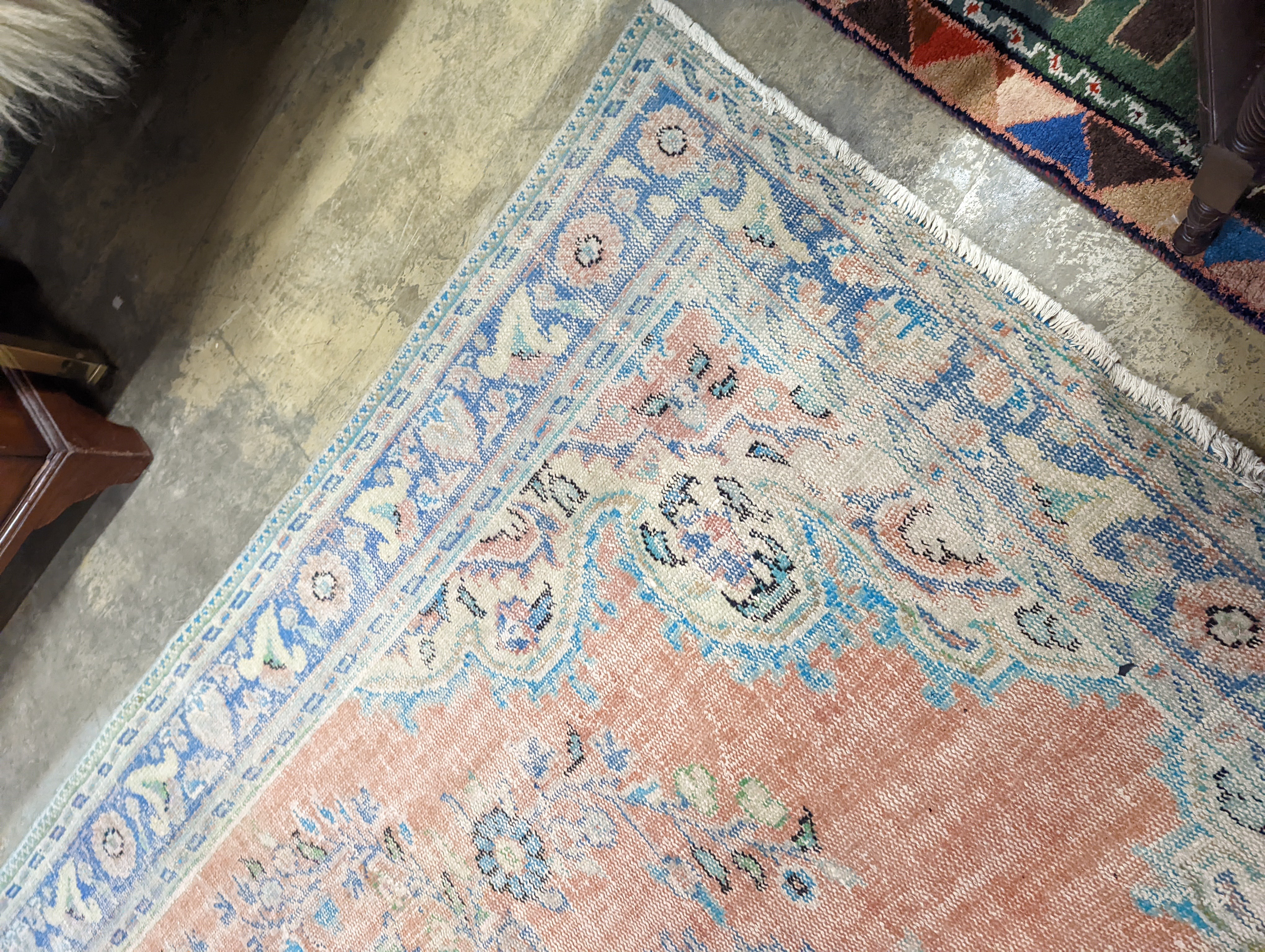 A North West Persian style faded wool carpet, 300 x 196cm